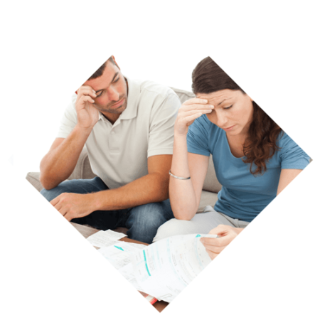 A young couple sitting on the couch stressing over their financial statements