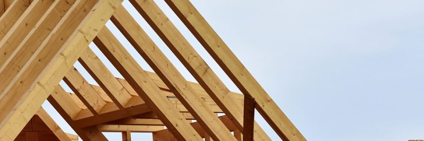 Roof trusses remain visible on an in-progress custom home build.