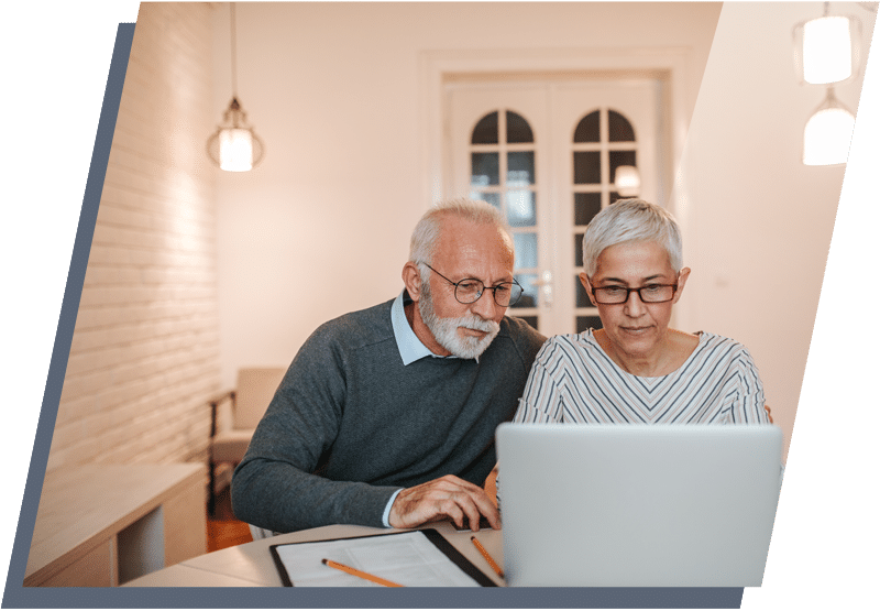 MObile-image-covid-19-page-3 Older man and woman sitting next to each other and looking at a laptop