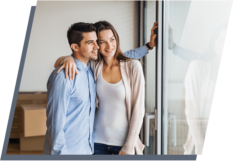 MObile-image-covid-19-page-4 Man and woman standing next to each other smiling while looking out a glass door