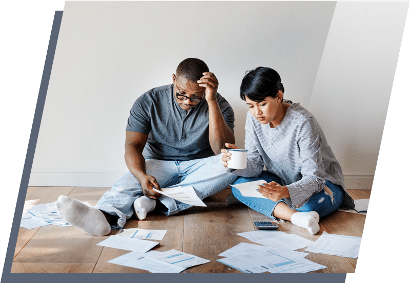 Man and woman sitting on the floor and looking at documents