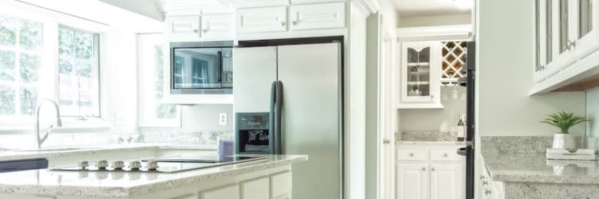 White, modern kitchen with stainless steel appliances