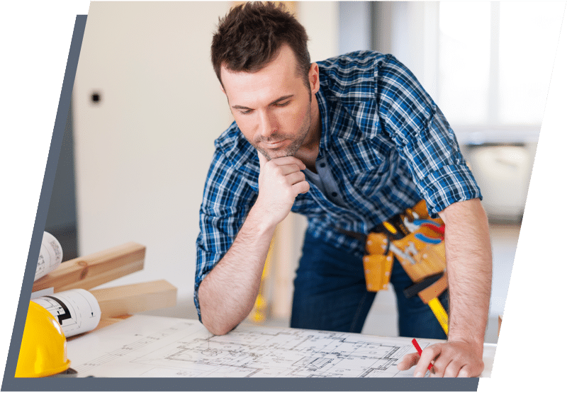 Construction worker looking at floorplans