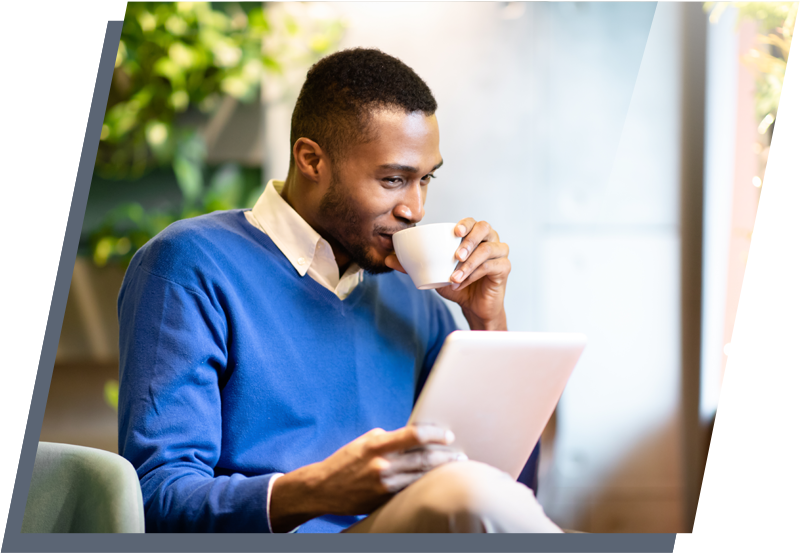 Man sitting in a chair drinking coffee