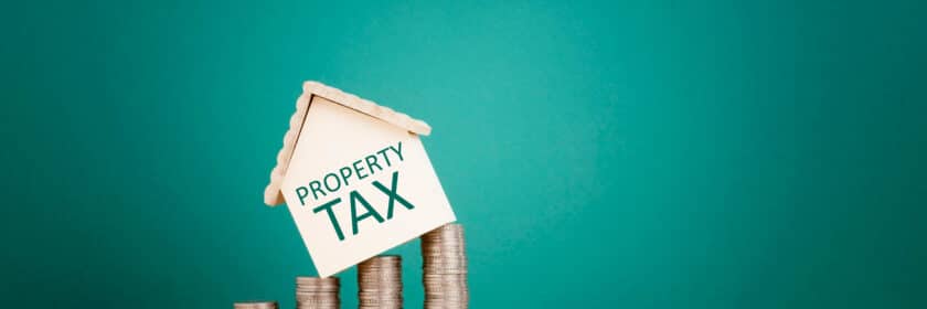 Property,Tax,Concept-house,Shape,On,Stacked,Coins
