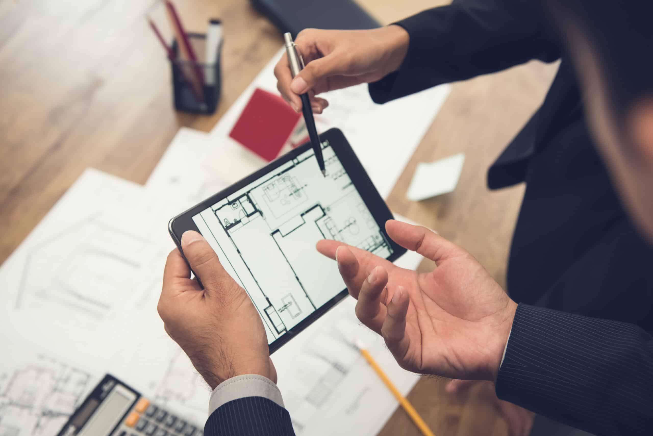 Real,Estate,Agent,With,Client,Or,Architect,Team,Discussing,A